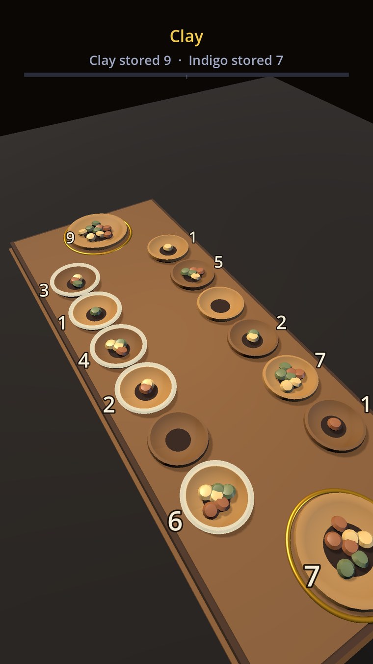 The Mancala board seen from a turned angle, the carved slab and its turned bowls standing in relief with the gilded rings around the two stores.